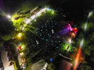 Drone view of Ribest at night, with crowd and stage