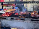 A variety of meats on a large grill