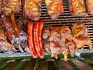 A variety of meats on a large grill