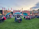 Crowds sitting at picnic tables