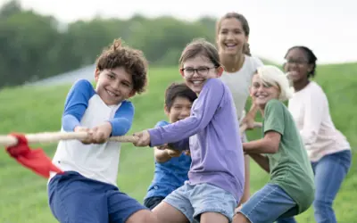 Group of kids pulling rope tug-of-war summer camps