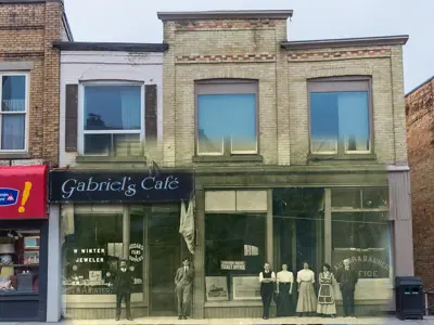 Colour image of businesses, with a black and white image of a building and people, inserted in the middle