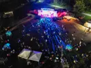 Drone view of Ribest at night, with crowd and stage