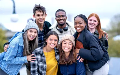 Group of teens huddled in autumn